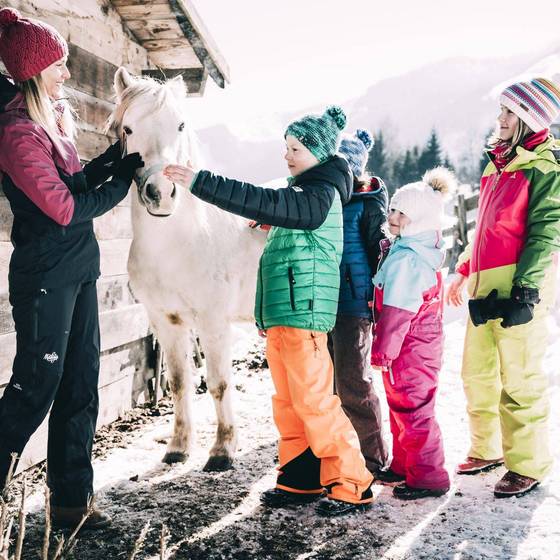 Kinder mit Pferd im Schnee (Kinderhotel Stegerhof, Foto: Armin Walcher)
